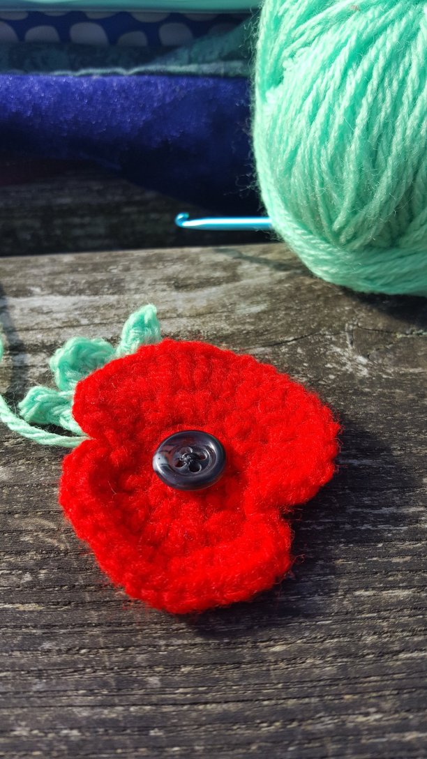 Red Poppy and leaf being hand crocheted